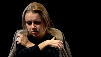 Upset poor woman covered with blanket suffering deep depression, frightened