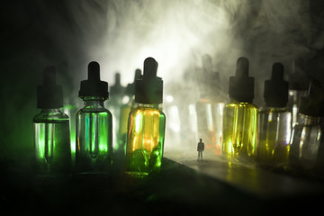Silhouette of a man standing in the middle of the road on a misty night with giant glass bottles...