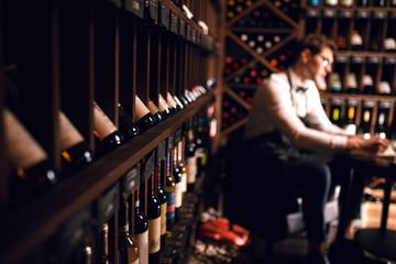 Professional sales personnel - sommelier will help choose right product just for clients. In Wine Boutique customers welcome to taste product that they have chosen. Winemaking. Occupations - obrazy, fototapety, plakaty