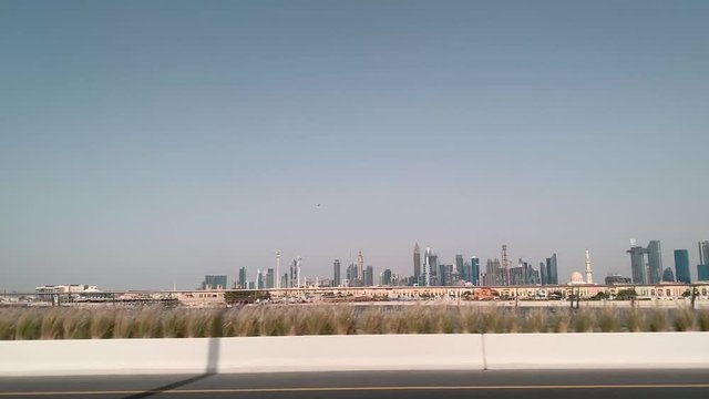 Dubai city , view from the car window at Dubai skyscrapers standing along the road
