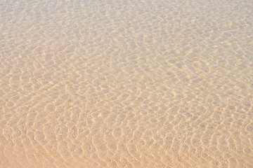 Little waves in shallow water at the beach