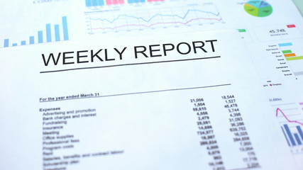 Obraz premium Weekly report lying on table, graphs charts and diagrams, official document