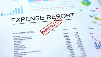 Expense report confidential, hand stamping seal on official document, statistics