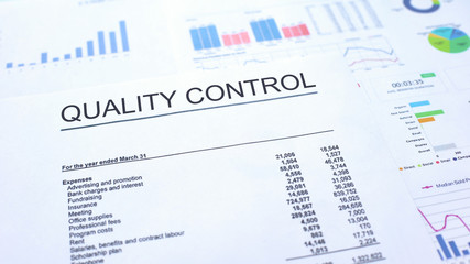 Quality control official document lying on table, graphs charts and diagrams