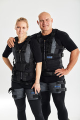Young man and woman in electric muscular suits are ready for work out. health care. close up photo,...