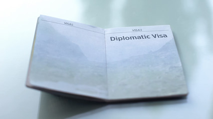 Diplomatic visa, opened passport lying on table in customs office, travelling