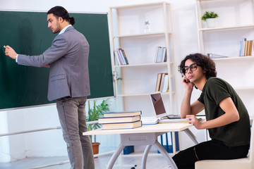 Fototapeta premium Young teacher and student in the classroom 