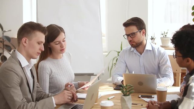 Female manager speaking at group meeting giving instructions delegating tasks