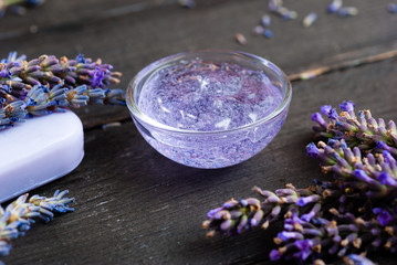 cleaning and skin care produst samples with lavender on black wooden