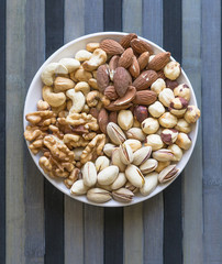 Healthy food. Nuts mix assortment on stone texture top view. Collection of different legumes for background image close up nuts, pistachios, almond, cashew nuts, peanut, walnut. image