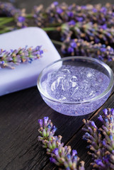 cleaning and skin care produst samples with lavender on black wooden
