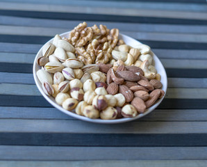 Healthy food. Nuts mix assortment on stone texture top view. Collection of different legumes for background image close up nuts, pistachios, almond, cashew nuts, peanut, walnut. image