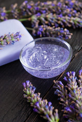 cleaning and skin care produst samples with lavender on black wooden