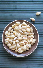 Healthy food  for background image close up pistachios nuts. Texture on top view Nuts pistachio on the cup plate