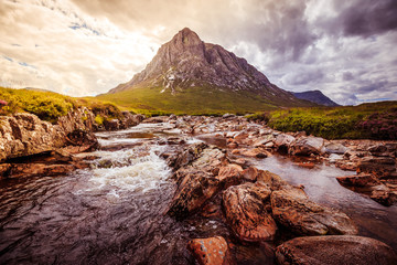 Beautiful river mountain landscape scenery in Glen Coe, Scottish Highlands, Scotland. Sunshine.