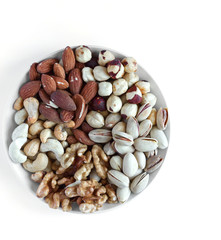 Healthy food. Nuts mix assortment on white grey table top view. Collection of different legumes for background image close up nuts, pistachios, almond, cashew nuts, peanut, walnut. image