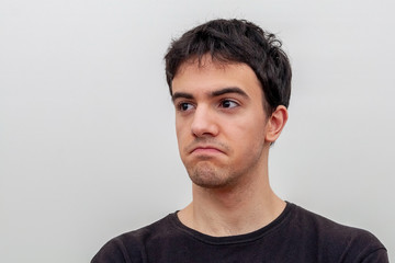 Fototapeta premium portrait of a frustrated young guy on white background
