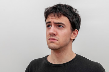 Fototapeta premium portrait of a sad young guy on white background