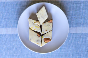 Oriental dessert halva with pistachio, almond, cashew nuts, peanut, walnut  on a  plate. Image....