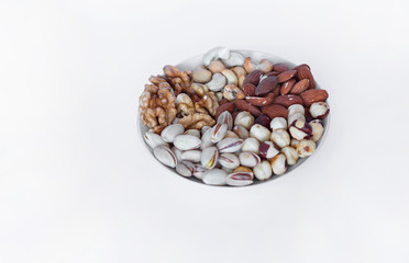 Healthy food. Nuts mix assortment on white grey table top view. Collection of different legumes for background image close up nuts, pistachios, almond, cashew nuts, peanut, walnut. image