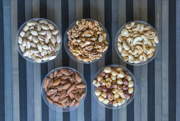 Healthy food. Nuts mix assortment on stone texture top view. Collection of different legumes for background image close up nuts, pistachios, almond, cashew nuts, peanut, walnut. image
