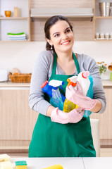 Young female contractor doing housework 