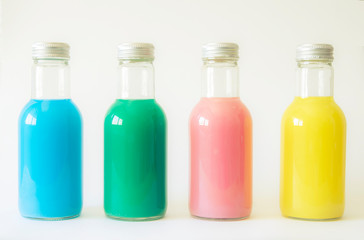 set of glass bottles with color liquid