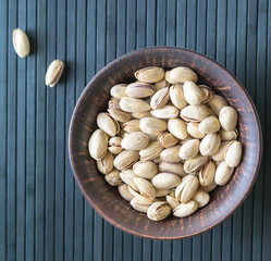 Healthy food  for background image close up pistachios nuts. Texture on top view Nuts pistachio on the cup plate