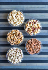 Healthy food. Nuts mix assortment on stone texture top view. Collection of different legumes for background image close up nuts, pistachios, almond, cashew nuts, peanut, walnut. image