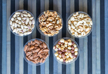 Healthy food. Nuts mix assortment on stone texture top view. Collection of different legumes for background image close up nuts, pistachios, almond, cashew nuts, peanut, walnut. image