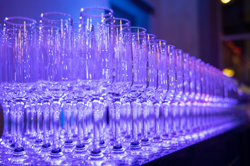 Fototapeta na wymiar Champagne glass on the table, blue color lights