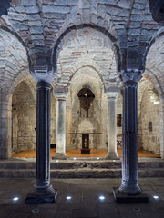 Crypt of a medieval abbey with carved stone columns.