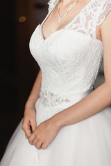 Obraz na płótnie Canvas bride in a white lace dress in the studio