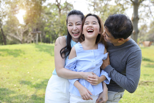 image of happiness family, daughter and parents having a happy time in the park with smiling and laughing