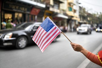 Citizen with flag welcomes diplomatic escort car passage