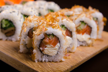 Japanese cuisine in the Ukrainian restaurant. Set sushi rolls with fish tuna, eel, salmon. Maki rolls on a wooden plate. Seafood Restaurant Menu