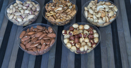 Healthy food. Nuts mix assortment on stone texture top view. Collection of different legumes for background image close up nuts, pistachios, almond, cashew nuts, peanut, walnut. image