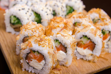 Japanese cuisine in the Ukrainian restaurant. Set sushi rolls with fish tuna, eel, salmon. Maki rolls on a wooden plate. Seafood Restaurant Menu