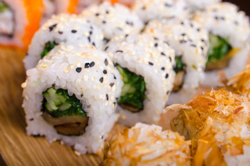 Japanese cuisine in the Ukrainian restaurant. Set sushi rolls with fish tuna, eel, salmon. Maki rolls on a wooden plate. Seafood Restaurant Menu
