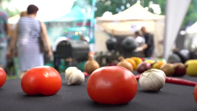Tomato garlic and people silhouette in popular barbecue competition. Static shot