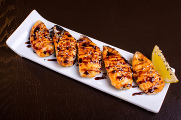 Menu of Ukrainian seafood restaurant. Baked mussels with garlic and cheese. Poured with sauce and sprinkled with sesame. Tasty lunch