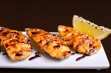 Menu of Ukrainian seafood restaurant. Baked mussels with garlic and cheese. Poured with sauce and sprinkled with sesame. Tasty lunch