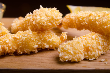 Large breaded shrimps are deep fried. Seafood in the Ukrainian restaurant. Fried shrimp on black background