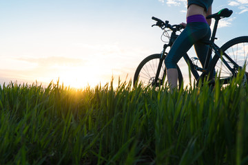 woman bike sunset. exercise at sunset.