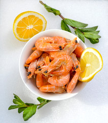 Boiled shrimps with lemon on a plate
