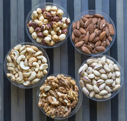 Healthy food. Nuts mix assortment on stone texture top view. Collection of different legumes for background image close up nuts, pistachios, almond, cashew nuts, peanut, walnut. image