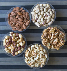 Healthy food. Nuts mix assortment on stone texture top view. Collection of different legumes for background image close up nuts, pistachios, almond, cashew nuts, peanut, walnut. image