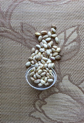 Healthy food  for background image close up pistachios nuts. Texture on top view Nuts pistachio on the cup plate