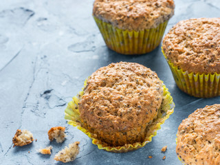 Muffins with chia seeds. Homemade muffin on blue concrete textured background