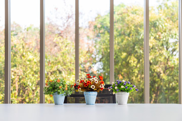 Grop of bouquet colorful artificial flower in vase on modern table